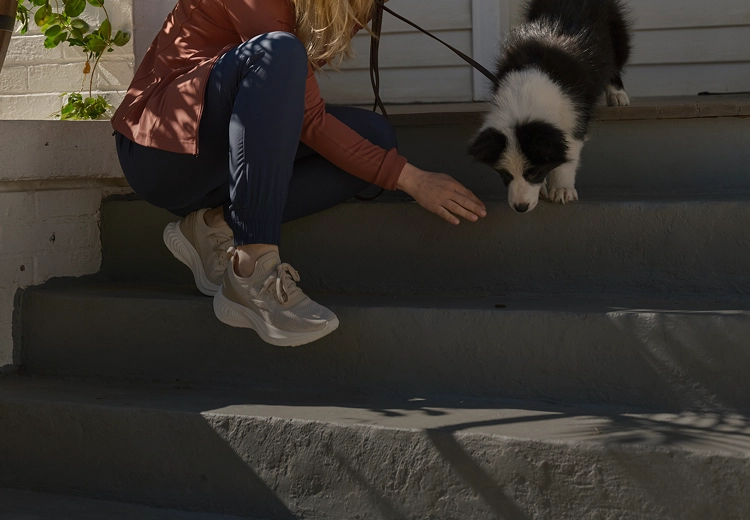 puppy with owner on the front porch