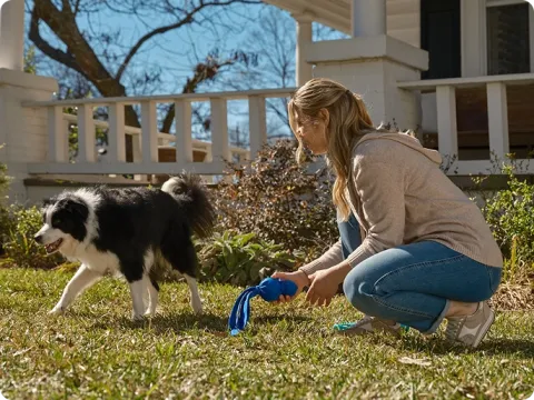 woman with dog in the yard