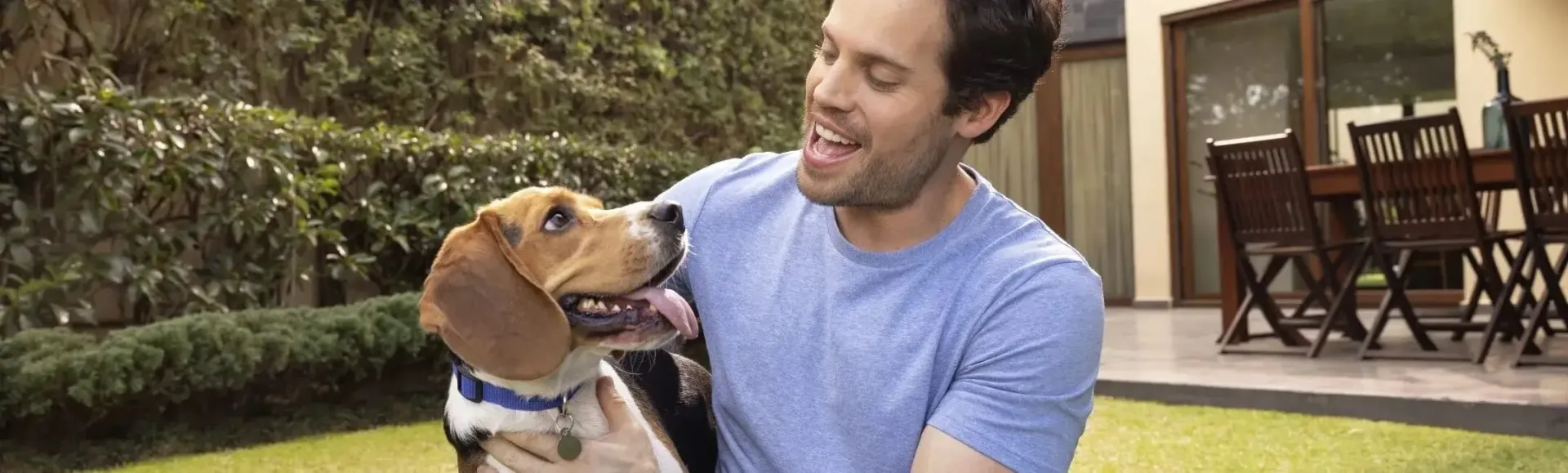 man and dog in backyard